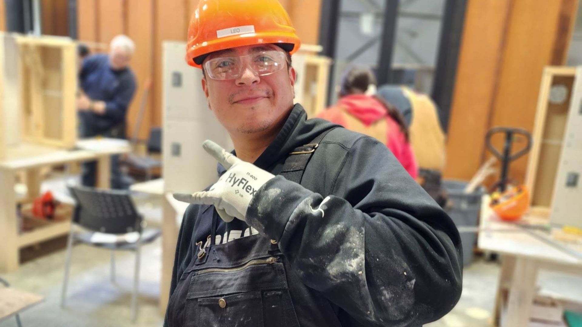 Young construction student happily smiles at the camera