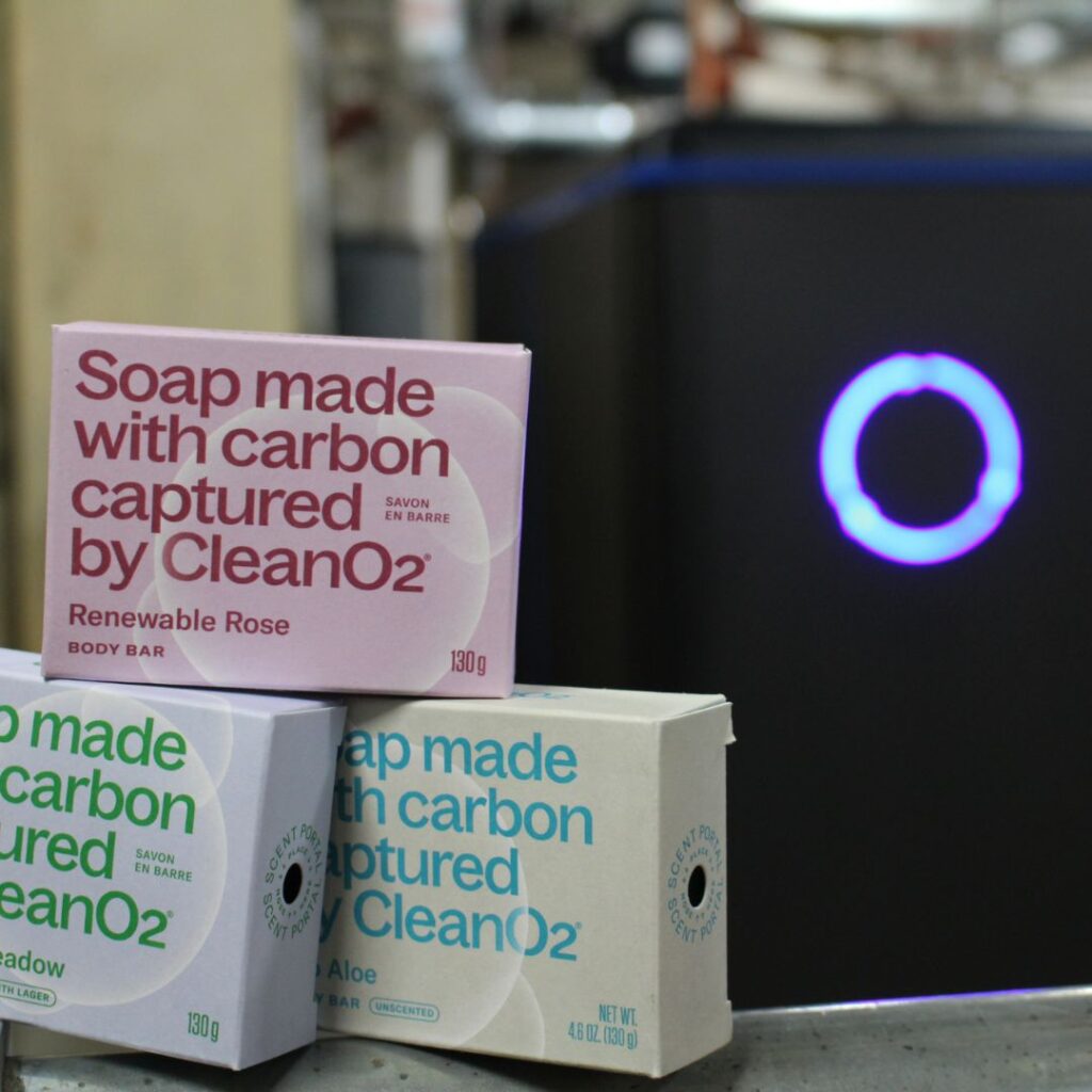 Photo of a CleanO2 small-scale carbon capture and storage CarbinX™ unit, and the soap made from upcycled and permanently sequestered CO2